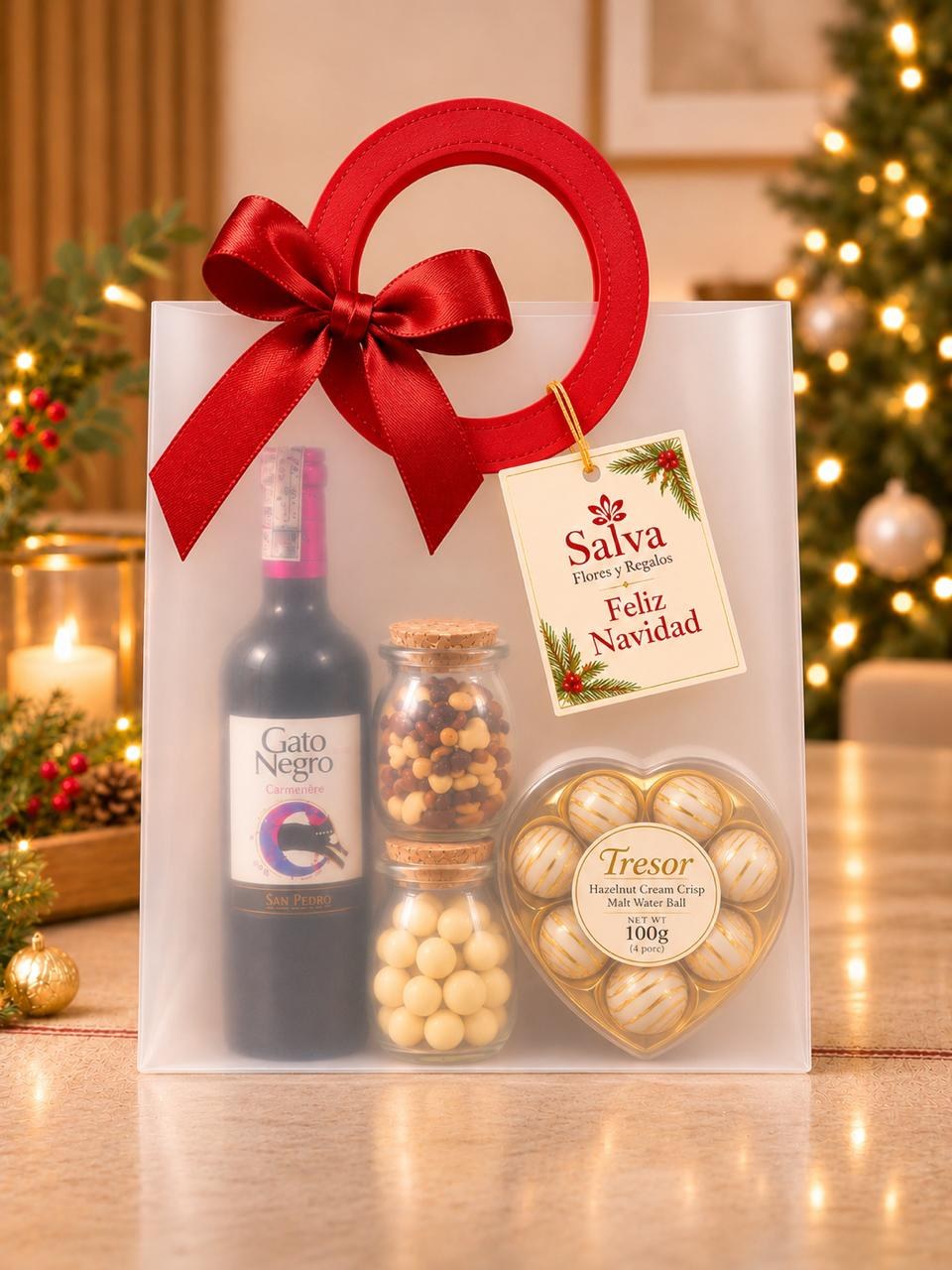 Ancheta de lujo navideña con vino tinto, chocolates, macadamias y frutos secos en bolsa de regalo con moño rojo – Salva Flores y Regalos